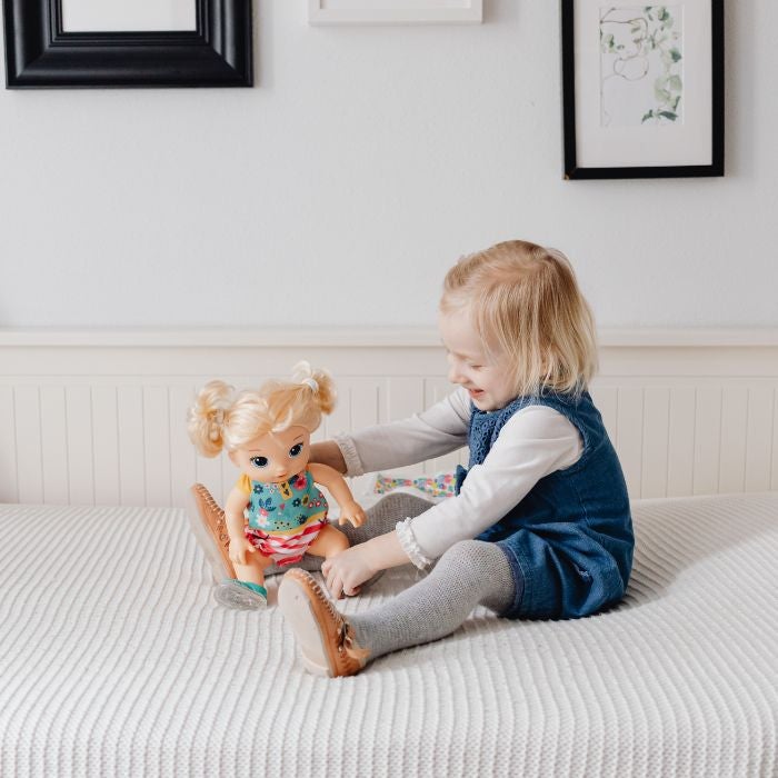 Child playing with doll