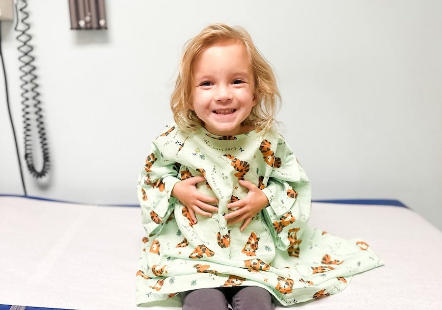 A small child on a patient's table in a doctor's office