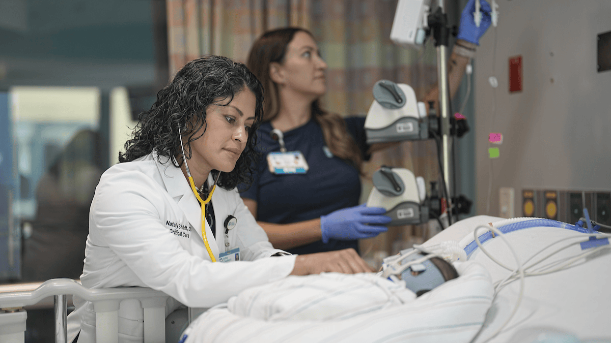 A PICU physician checks on a patient