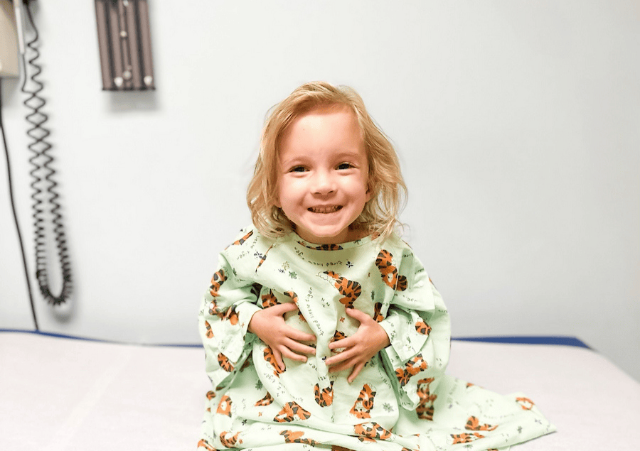A small child on a patient's table in a doctor's office