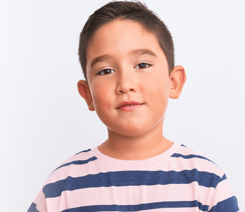 A young boy looks at the camera
