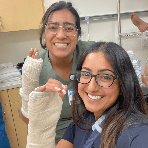 Two pediatric residents practice casting