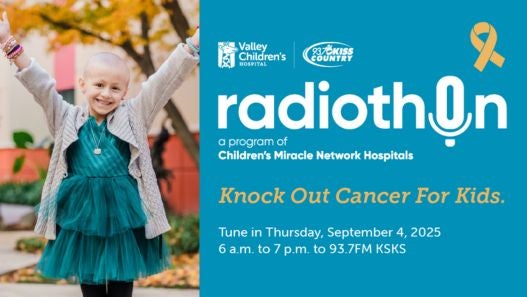 Valley Children's Patient Abby Posing for Photo with Radiothon Information