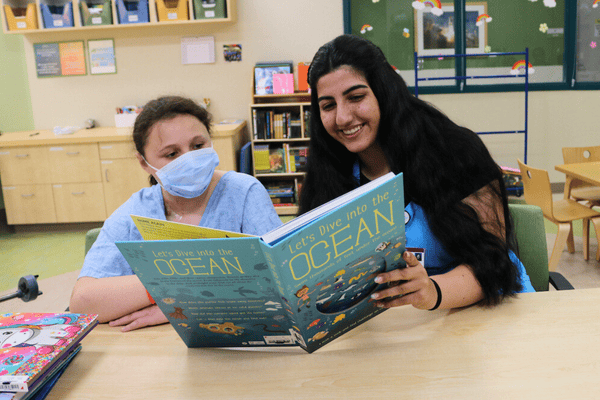 A Valley Children's volunteer reads with a young patient