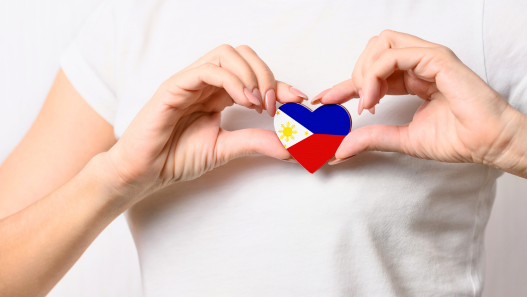 Person holding a heart with the phillipines flag